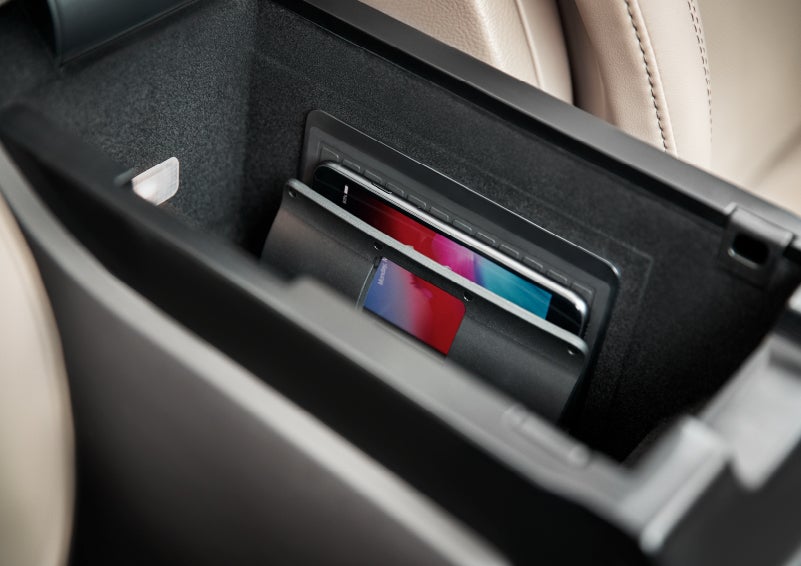 A smartphone device is securely tucked into the available wireless charging pad for an effortless energy boost | Sentry Lincoln in Medford MA