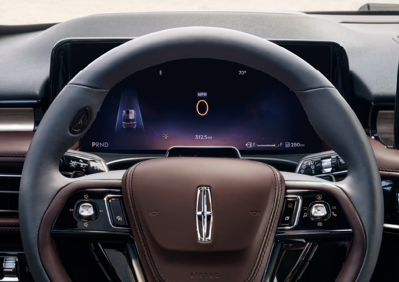 The steering wheel of 2025 Lincoln Aviator® SUV is shown with black and brown accents. | Sentry Lincoln in Medford MA