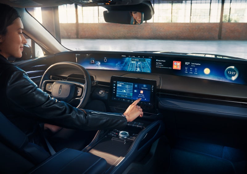 The driver of a 2025 Lincoln Nautilus® SUV interacts with the center touchscreen. | Sentry Lincoln in Medford MA