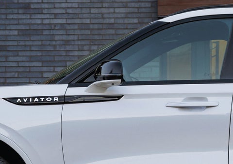 The driver’s side door and fender badging of a white 2026 Lincoln Aviator® SUV are showcased. | Sentry Lincoln in Medford MA