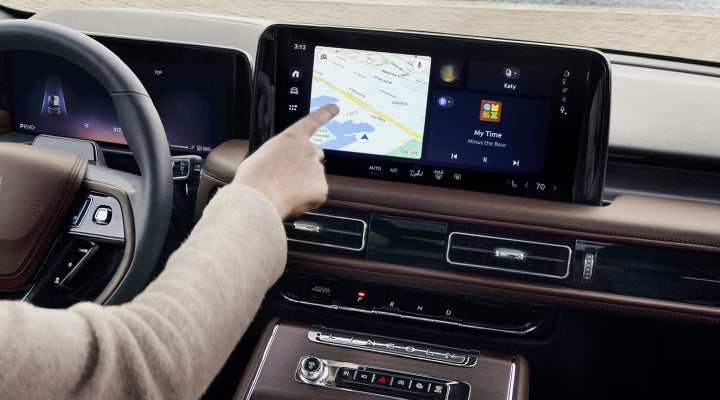 A person is tapping the center display touchscreen of a 2026 Lincoln Aviator® SUV. | Sentry Lincoln in Medford MA