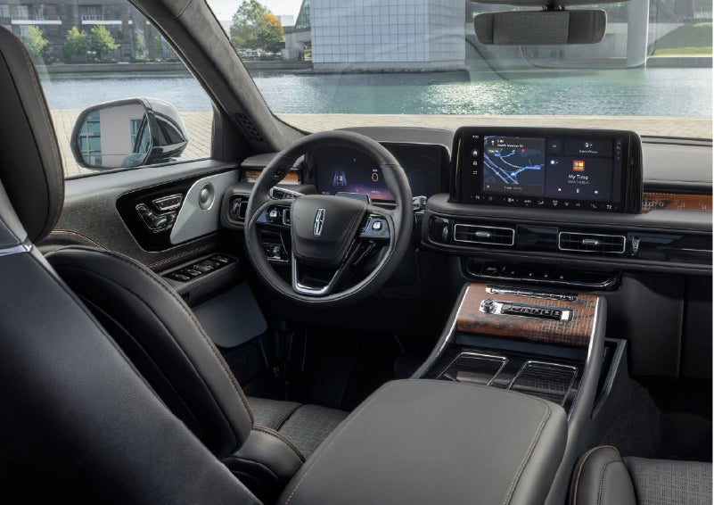 The interior of the 2026 Lincoln Aviator® SUV is shown parked with a view of a harbor through the windshield. | Sentry Lincoln in Medford MA