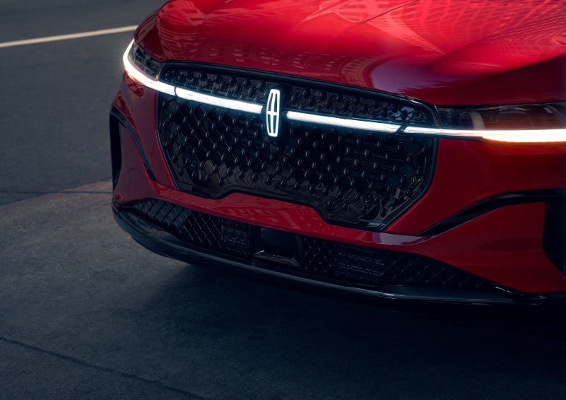 The available front LED light bar and center Lincoln Star logo glow at dusk. | Sentry Lincoln in Medford MA