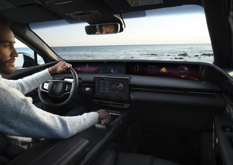 A driver of a parked 2026 Lincoln Nautilus® SUV takes a relaxing moment at a seaside overlook while inside his Nautilus. | Sentry Lincoln in Medford MA