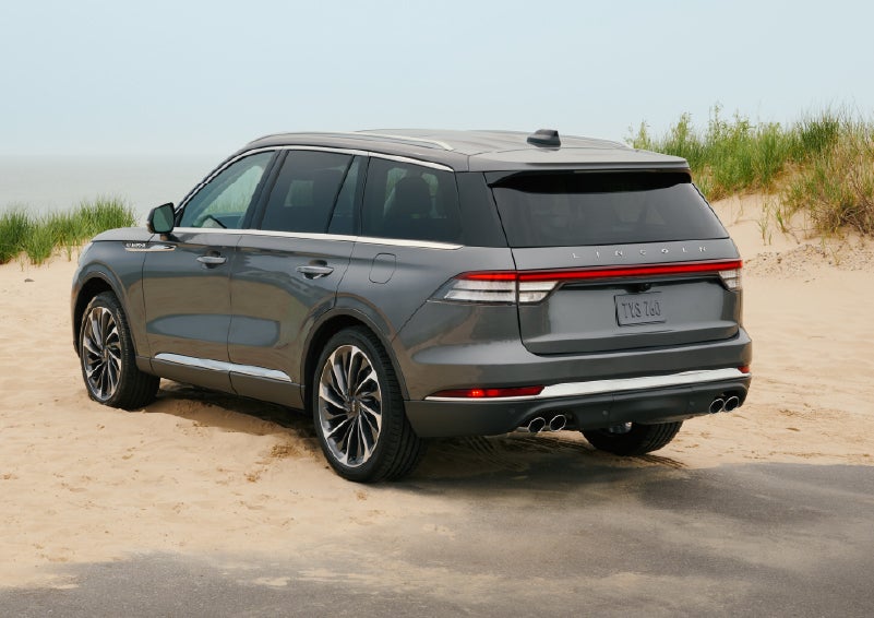 A 2027 Lincoln Aviator® SUV is parked next to sand dunes. | Sentry Lincoln in Medford MA