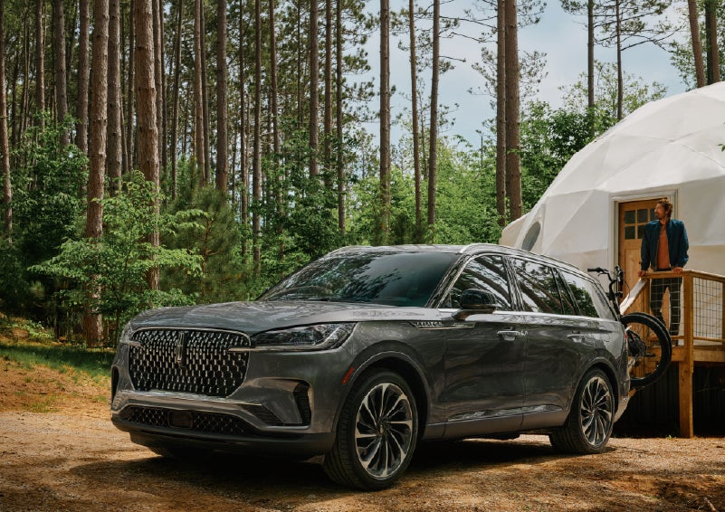 A 2027 Lincoln Aviator® is parked next to a high end glamping site. | Sentry Lincoln in Medford MA
