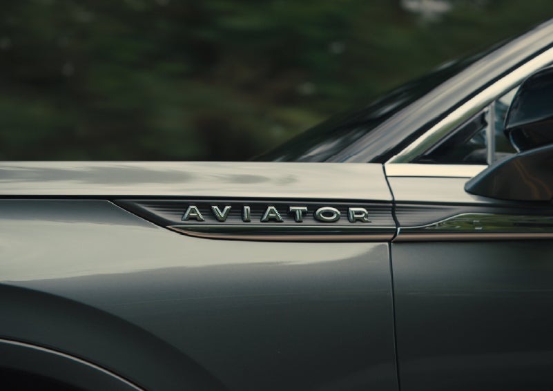 The driver’s side door and fender badging of a gray 2027 Lincoln Aviator® SUV are showcased. | Sentry Lincoln in Medford MA