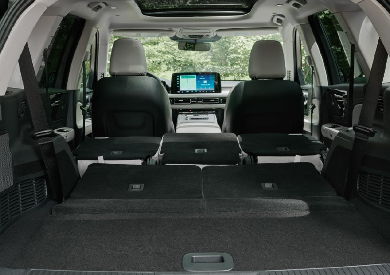 A rear to front view of the interior of a 2027 Lincoln Aviator® Black Label™ SUV shows the third and second rows folded flat | Sentry Lincoln in Medford MA