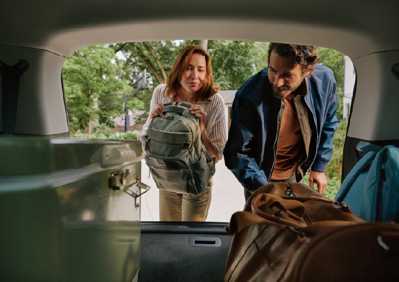 A couple loads luggage into the rear of a 2027 Lincoln Aviator® Black Label™ SUV..e 202 | Sentry Lincoln in Medford MA