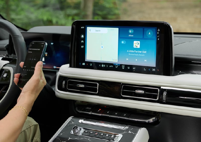 A person pairs thier phone with the center touchscreen of a 2027 Lincoln Aviator® Black Label™ SUV | Sentry Lincoln in Medford MA